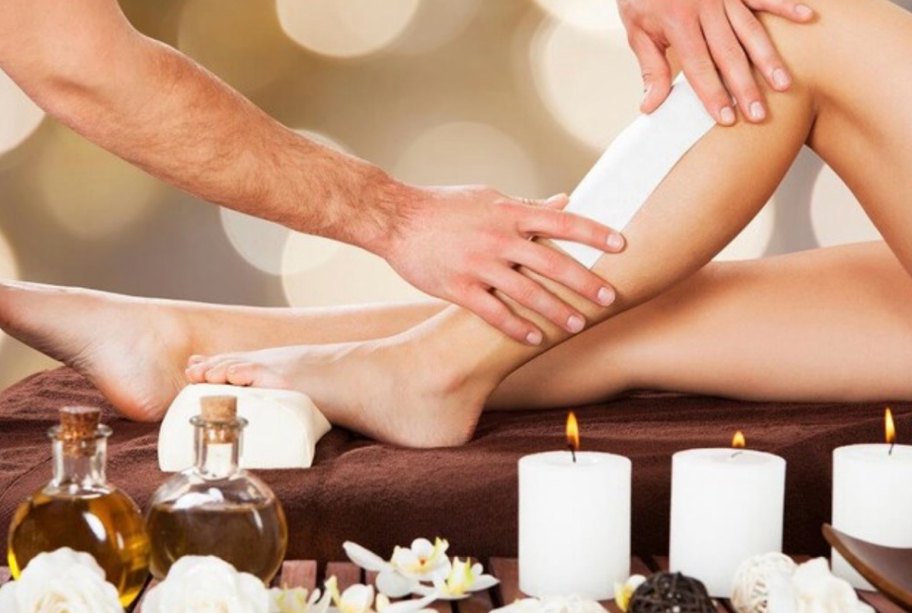 Leg waxing at Tranquil Therapy, with candles and massage oils